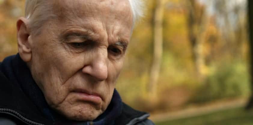 Distressed Elderly Gentleman Walking Outdoors Stock Photo