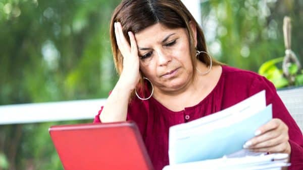Injured Woman Reading A Social Security Denial Letter