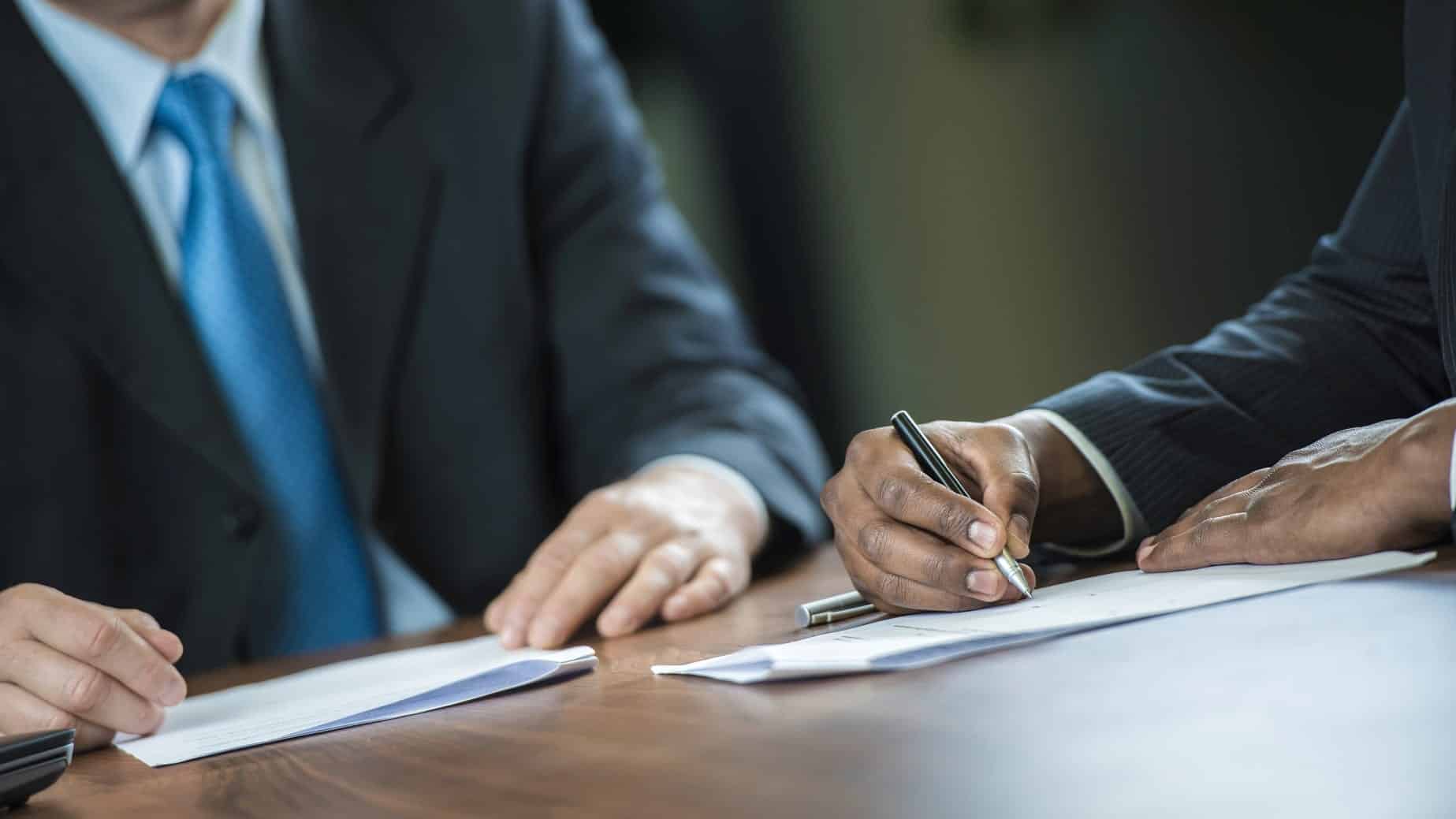 Attorney Advising Client To Sign Legal Document Stock Photo