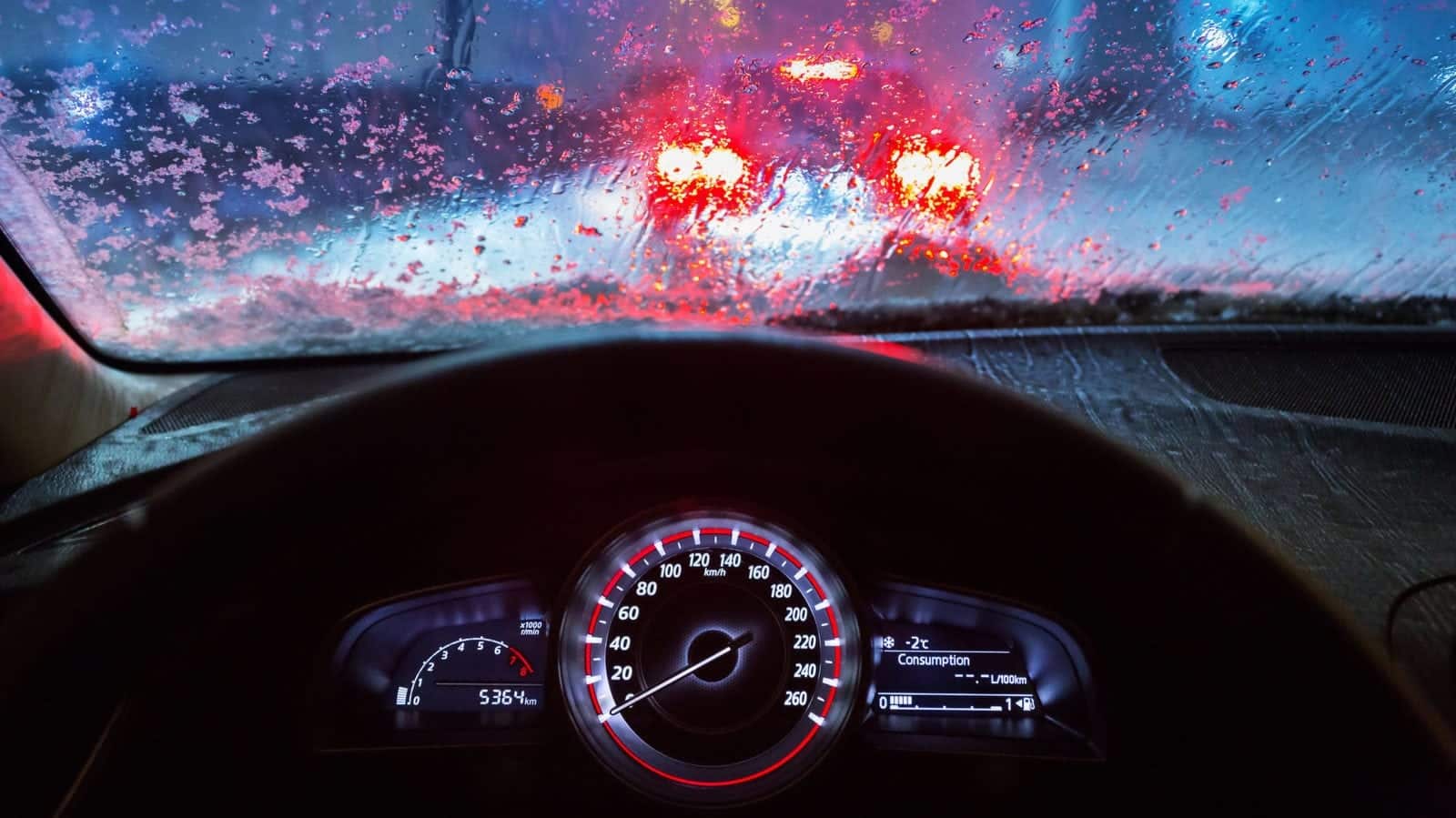 Man Driving His Car At Night During Rainfall Stock Photo
