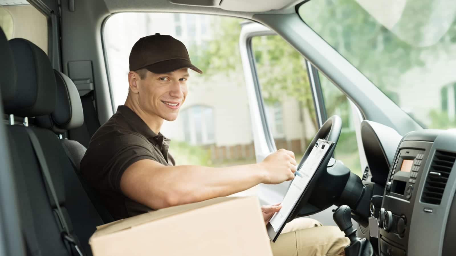 Delivery Driver Driving A Delivery Van Stock Photo
