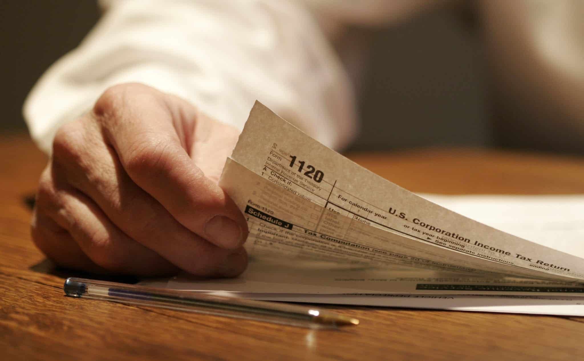 Man Completing Income Tax Documentation Stock Photo