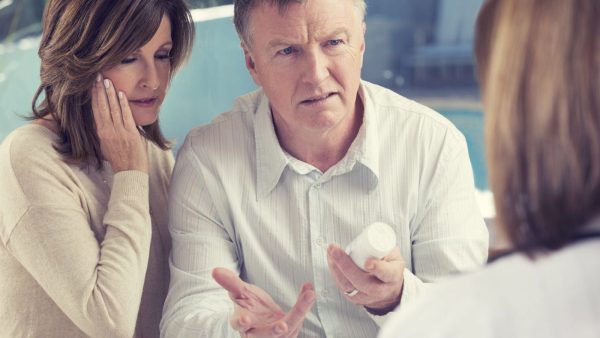 Mature Couple Meeting With Doctor Privately Stock Photo