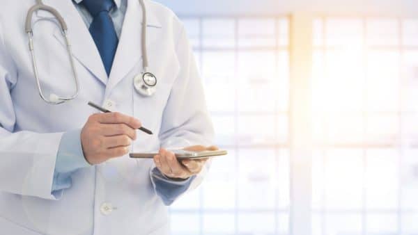 Doctor Writing A Prescription Stock Photo