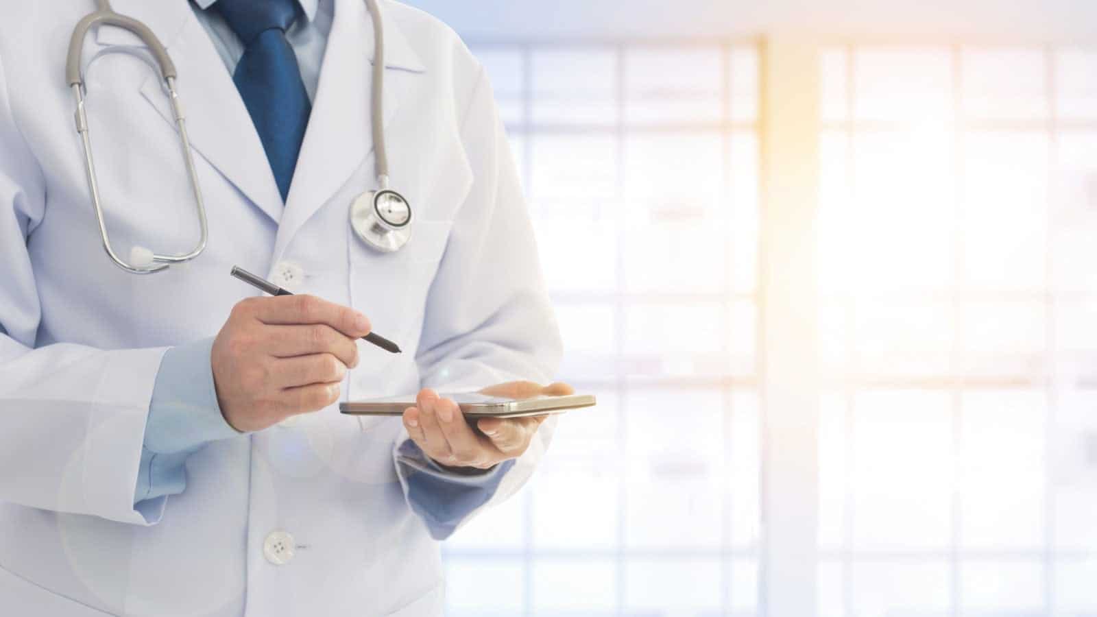 Doctor Writing A Prescription Stock Photo