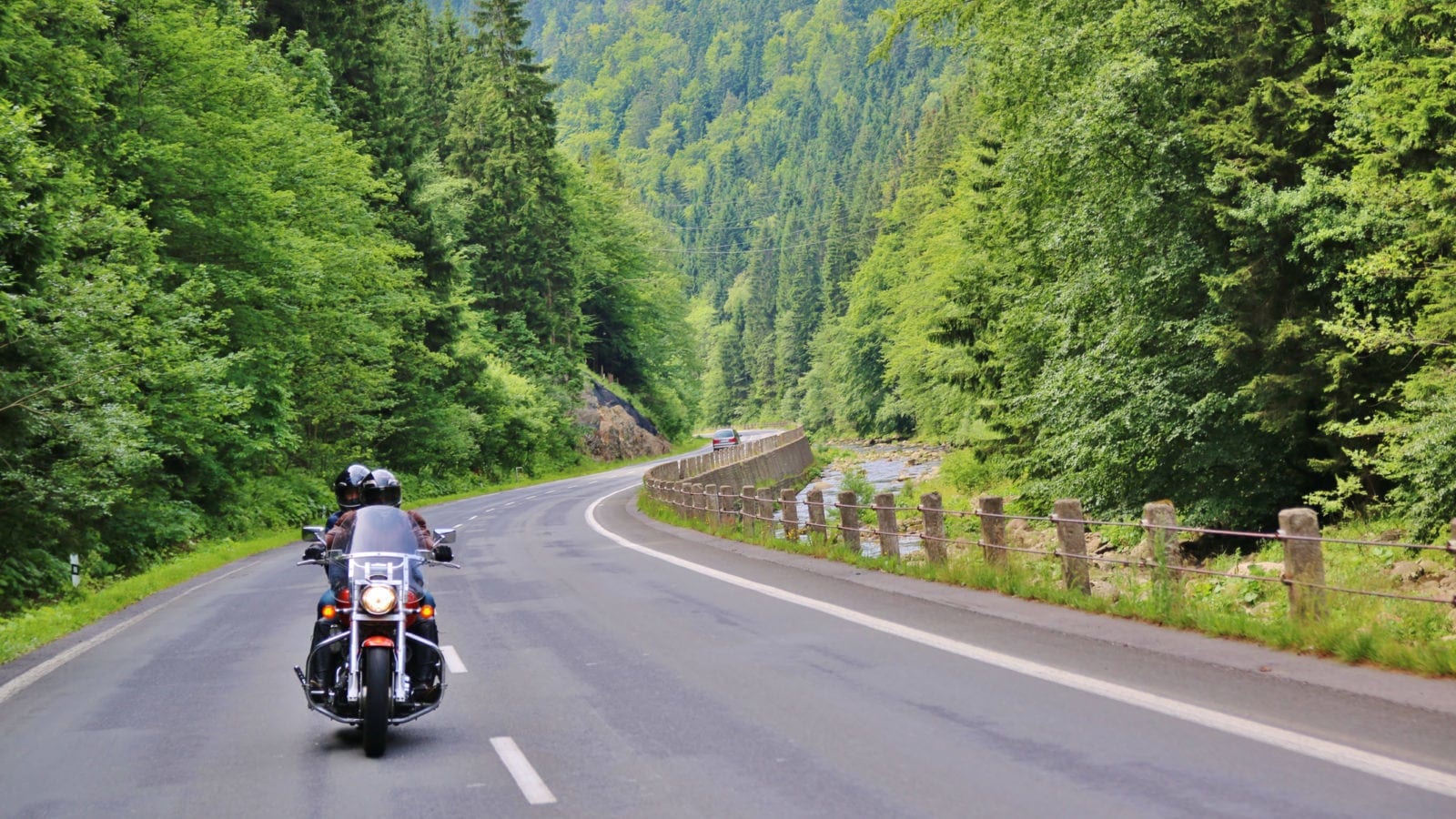 Two People Riding A Motorcycle In A Rural Area Stock Photo