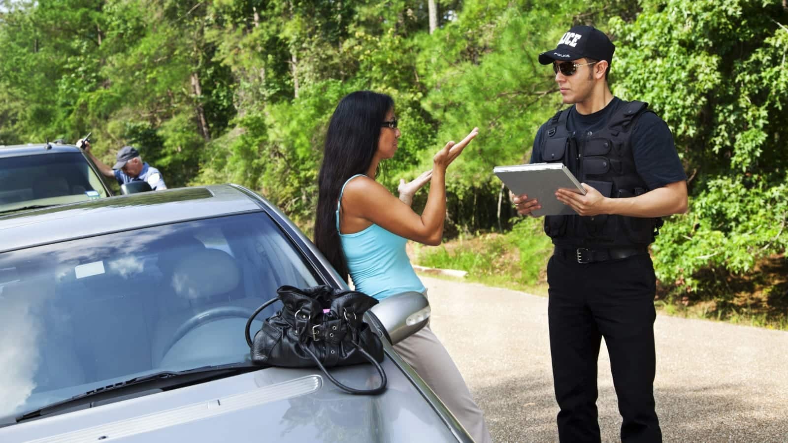 Woman Helping Police Officer Complete Police Report Stock Photo