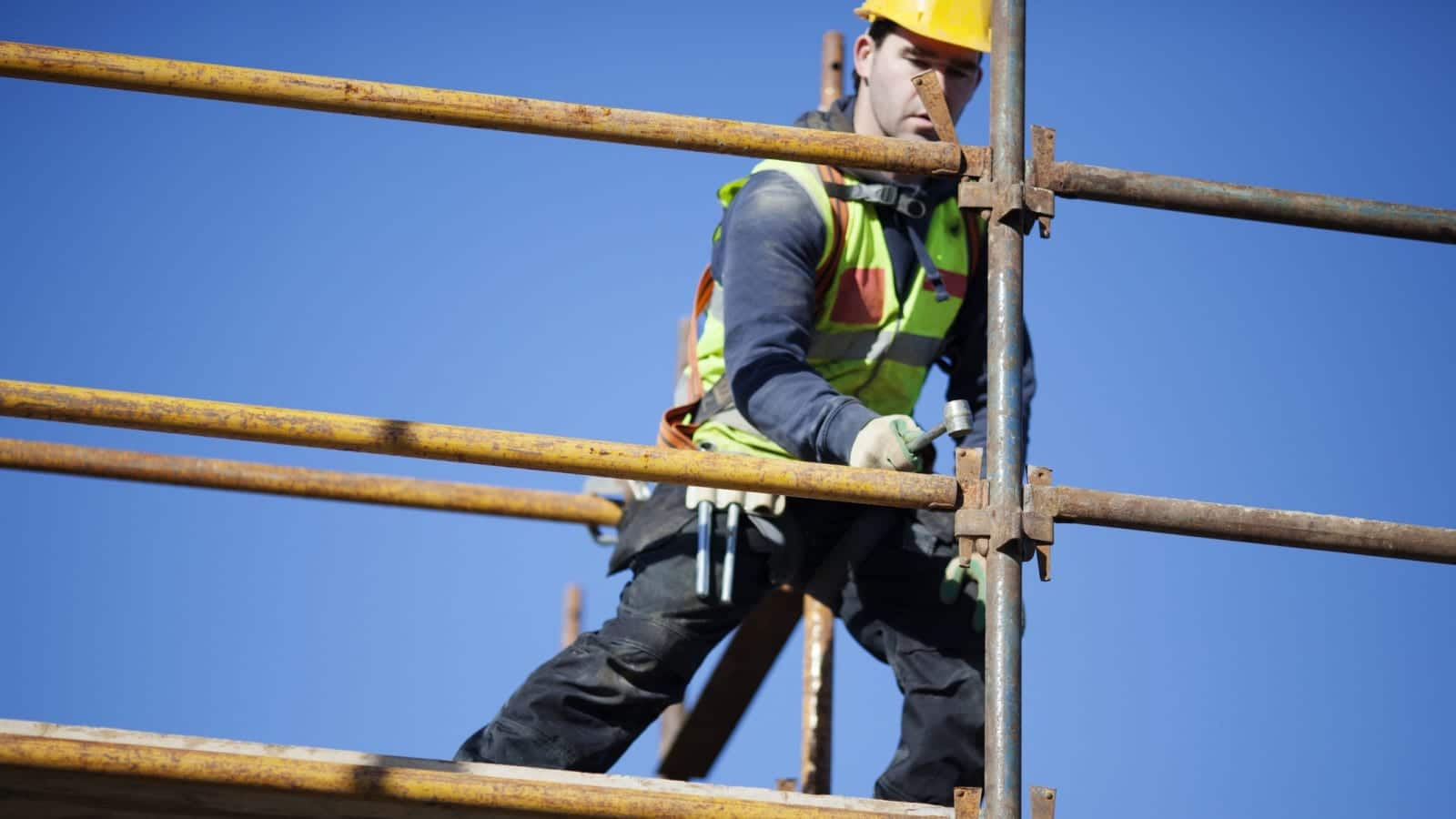 Construction Worker Working On Scaffolding Stock Photo