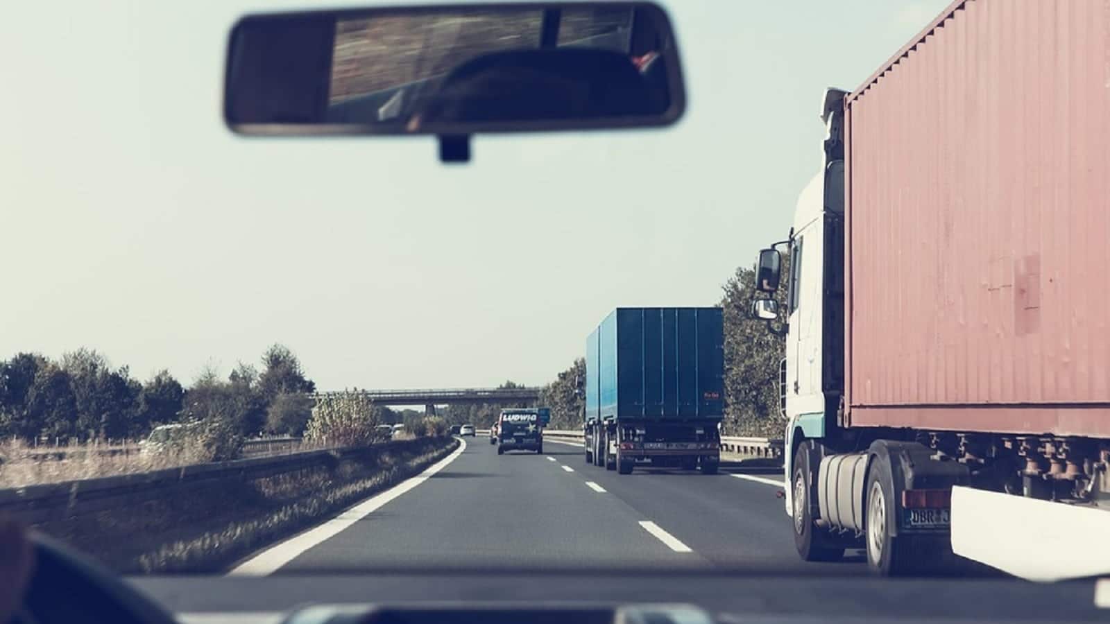 Semi Trucks Driving On The Interstate Stock Photo